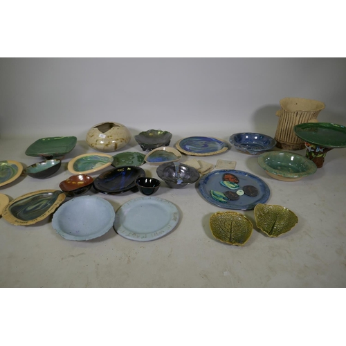 151 - A quantity of studio pottery, planters, plates and bowls, marked AF, plate with Oscar Wilde quote 32... 