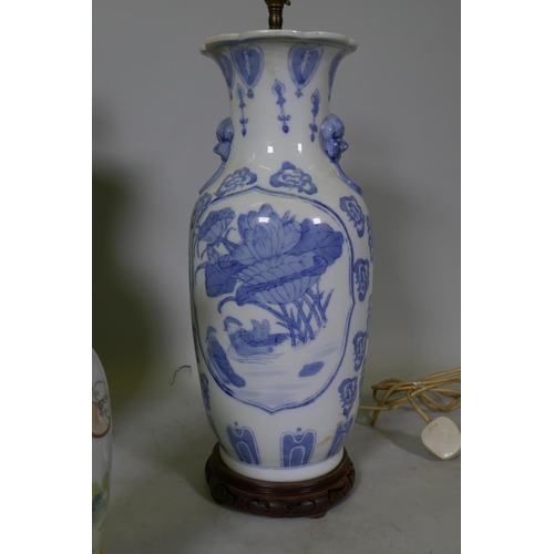 153 - A Chinese ceramic table lamp with blue and white decoration and wood base, 58cm high, and two others