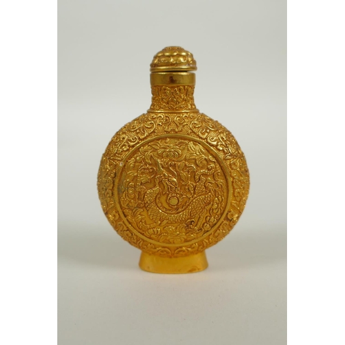 163 - A Chinese gilt bronze snuff bottle with raised dragon and floral decoration, 4 character mark to bas... 