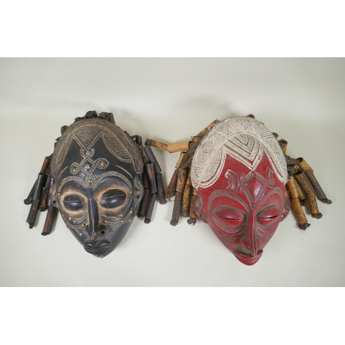 17 - Two African Angolan carved wood Chokwe masks, one painted, 28cm