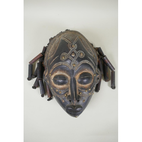 17 - Two African Angolan carved wood Chokwe masks, one painted, 28cm