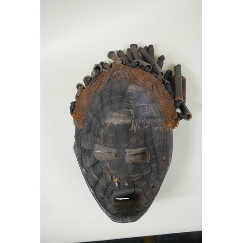 17 - Two African Angolan carved wood Chokwe masks, one painted, 28cm