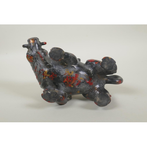 181 - An oriental filled bronze figure of a boar with remnants of gilt and red lacquer patina, 20cm long