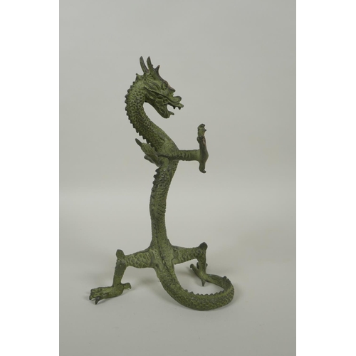 183 - A Chinese bronze figure of a dragon with gilt highlights, 24cm high