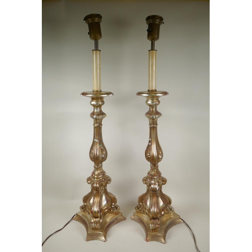 184 - A pair of gilt composition rococo style table lamps, 88cm high