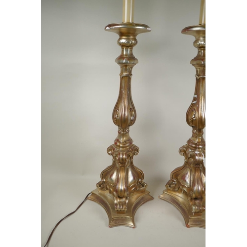 184 - A pair of gilt composition rococo style table lamps, 88cm high