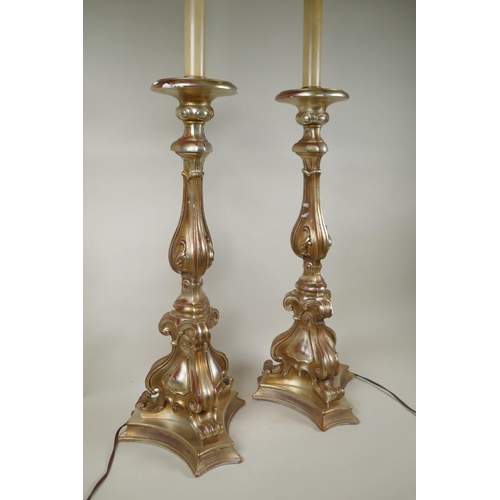 184 - A pair of gilt composition rococo style table lamps, 88cm high