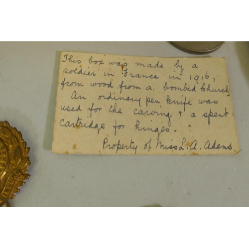 189 - A WWI trench art carved box, Royal Engineers 1916, with card explaining it was made from the wood fr... 