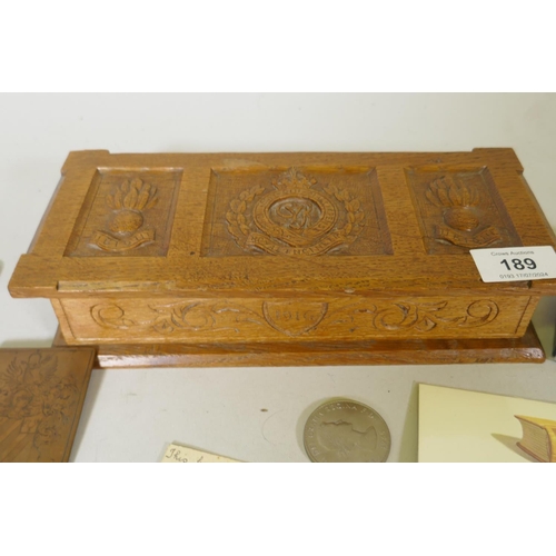 189 - A WWI trench art carved box, Royal Engineers 1916, with card explaining it was made from the wood fr... 