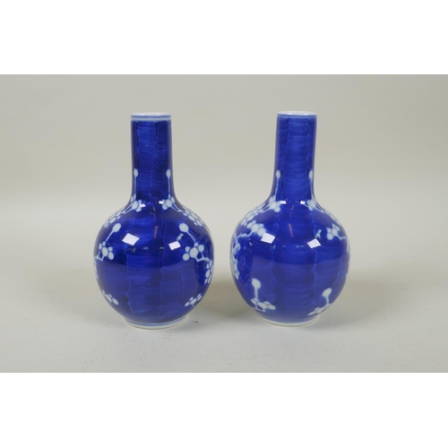 191 - A pair of late C19th/early C20th Chinese blue and white porcelain bottle vases decorated with prunus... 