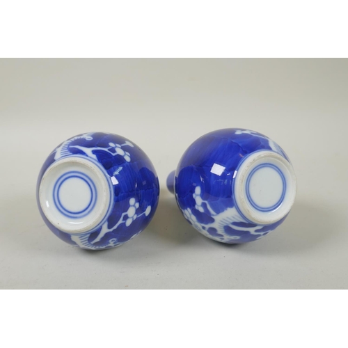 191 - A pair of late C19th/early C20th Chinese blue and white porcelain bottle vases decorated with prunus... 