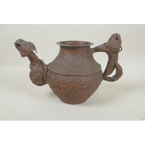 197 - A Tibetan coppered metal kettle with a dragon handle and spout, and repousse vine decoration, 17cm h... 