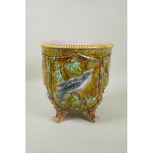 198 - An antique Majolica jardiniere decorated with birds and flowers, raised on four scrolling feet, 23cm... 