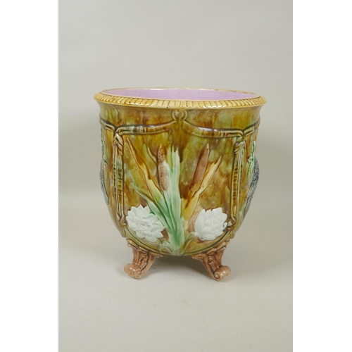 198 - An antique Majolica jardiniere decorated with birds and flowers, raised on four scrolling feet, 23cm... 