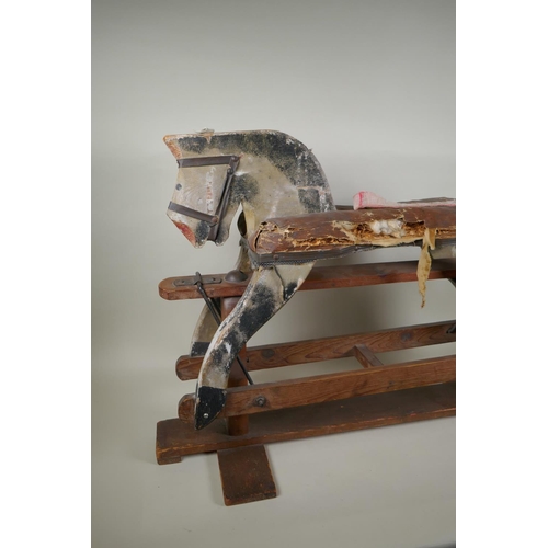 207 - An antique painted pine rocking horse, 82cm long, 56cm high