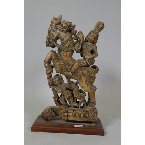 21 - An Indian carved wood figure of a warrior on prancing horse, 48cm high