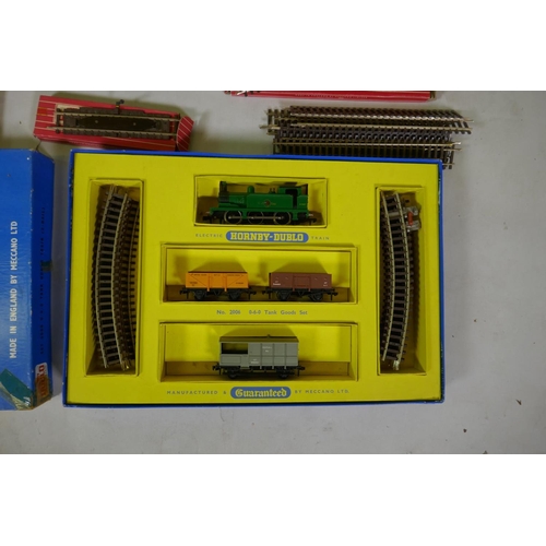 212 - A collection of Hornby Dublo 00 gauge rolling stock, scenery buildings and track, most in original b... 