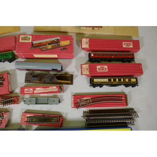 212 - A collection of Hornby Dublo 00 gauge rolling stock, scenery buildings and track, most in original b... 