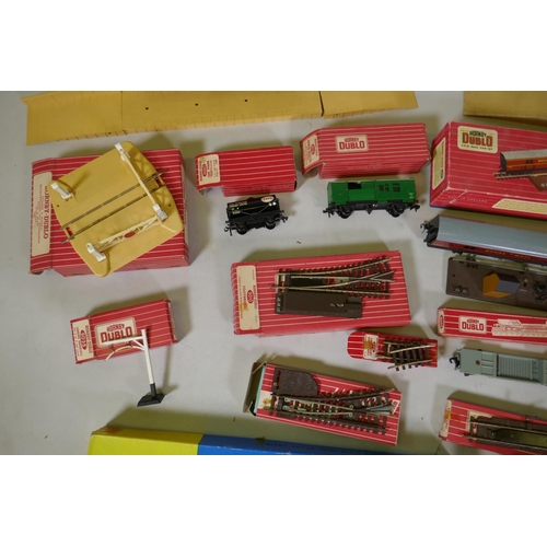 212 - A collection of Hornby Dublo 00 gauge rolling stock, scenery buildings and track, most in original b... 