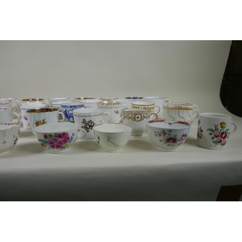 213 - A collection of English C18th and C19th porcelain tea cups and coffee cans, many with hand painted d... 