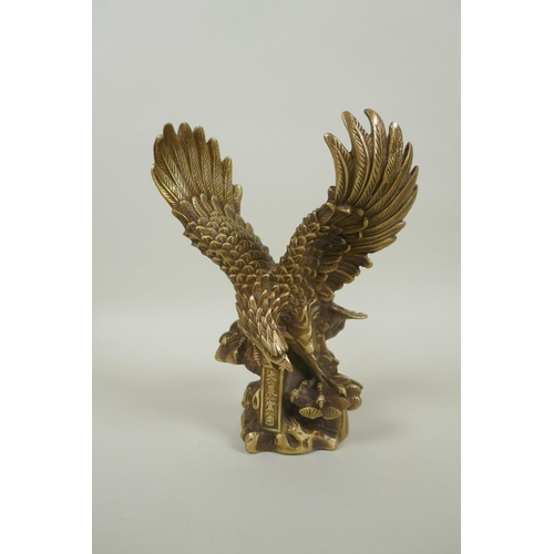 216 - A Chinese filled gilt bronze figure of an eagle, impressed 4 character mark, 19cm high