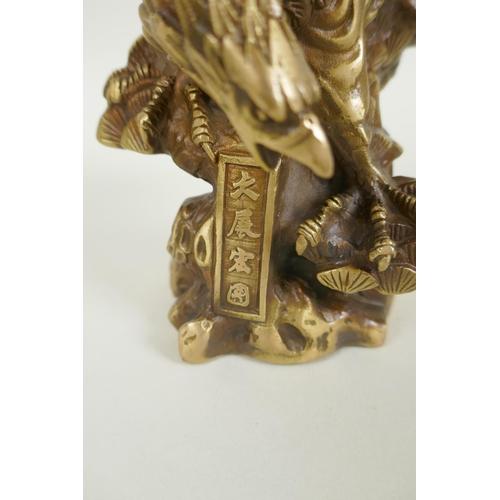 216 - A Chinese filled gilt bronze figure of an eagle, impressed 4 character mark, 19cm high