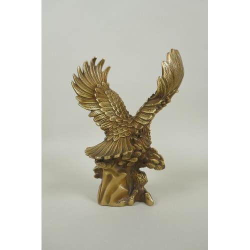 216 - A Chinese filled gilt bronze figure of an eagle, impressed 4 character mark, 19cm high