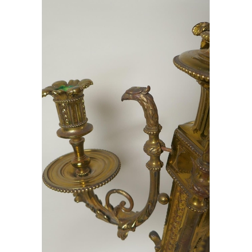 217 - A pair of gilt bronze four branch candelabra, decorated with swags, masks and arrow fletchings, the ... 