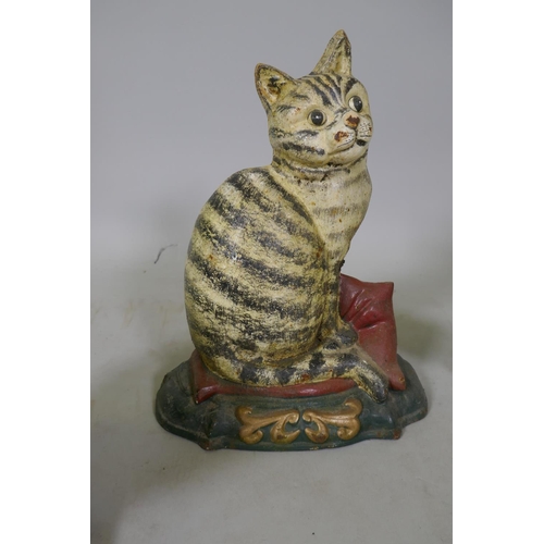 219 - A painted iron doorstop in the form of a cat, another in the form of a basket of flowers, and two co... 