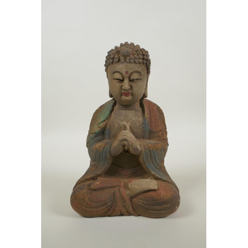 220 - A Chinese carved, painted and distressed wood Buddha, 22cm high