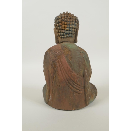 220 - A Chinese carved, painted and distressed wood Buddha, 22cm high