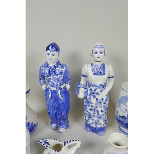 227 - A quantity of assorted Delft blue and white porcelain, to include figural decanters/bottles, vases, ... 