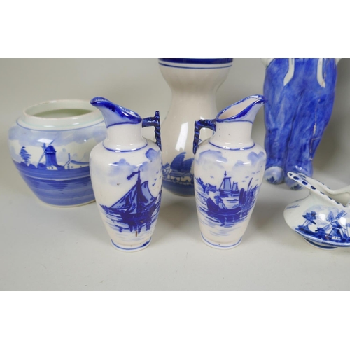 227 - A quantity of assorted Delft blue and white porcelain, to include figural decanters/bottles, vases, ... 