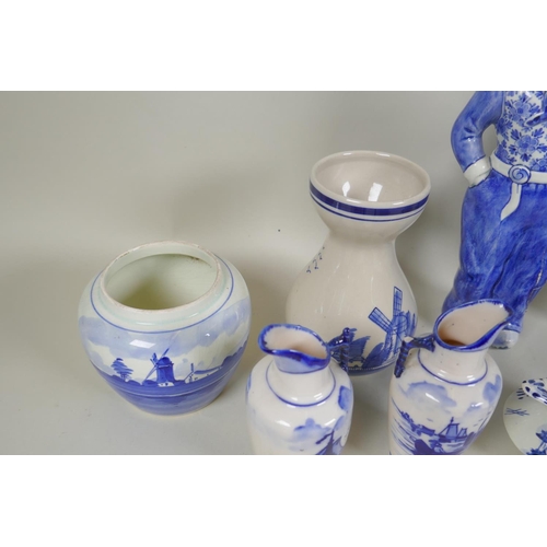 227 - A quantity of assorted Delft blue and white porcelain, to include figural decanters/bottles, vases, ... 