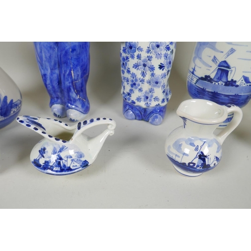 227 - A quantity of assorted Delft blue and white porcelain, to include figural decanters/bottles, vases, ... 