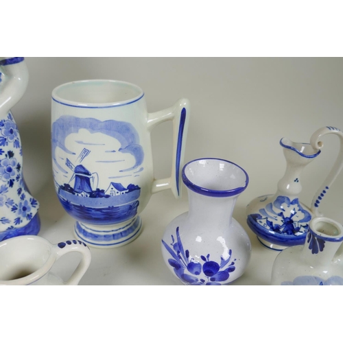 227 - A quantity of assorted Delft blue and white porcelain, to include figural decanters/bottles, vases, ... 