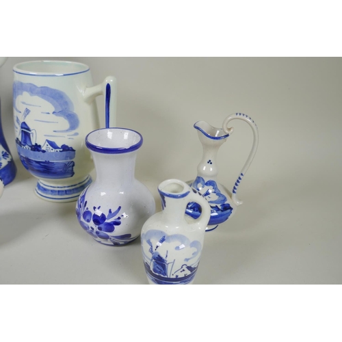 227 - A quantity of assorted Delft blue and white porcelain, to include figural decanters/bottles, vases, ... 