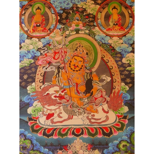 235 - A Tibetan printed thangka depicting Jambhala seated on the back of a lion, 70 x 90cm