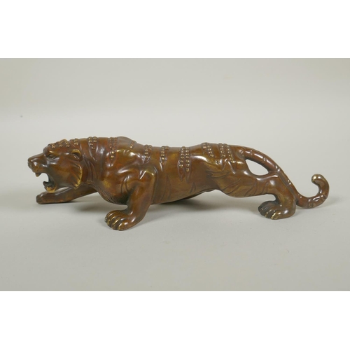 248 - A Chinese filled bronze figure of a tiger, impressed mark to base, 24cm long