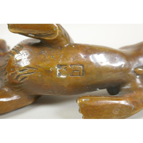 248 - A Chinese filled bronze figure of a tiger, impressed mark to base, 24cm long