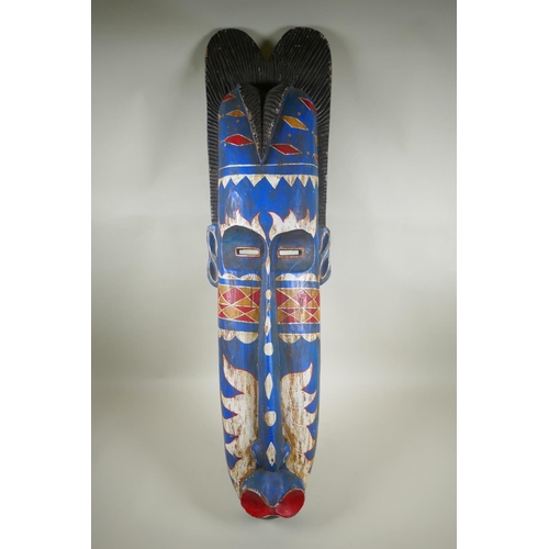 249 - An African painted wood wall mask, 100cm