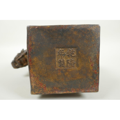 259 - A Chinese filled bronze figure of a kylin, with remnants of gilt and red lacquer patina, impressed Q... 