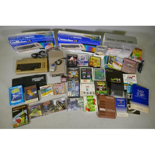 26 - Two Commodore 64, accessories, floppy disk readers, programs and games to include Ghostbusters, Supe... 