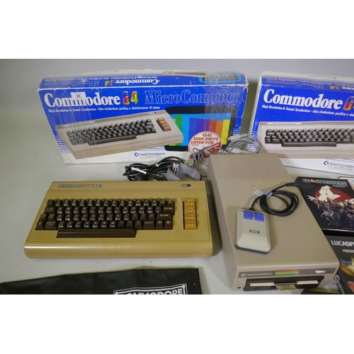 26 - Two Commodore 64, accessories, floppy disk readers, programs and games to include Ghostbusters, Supe... 