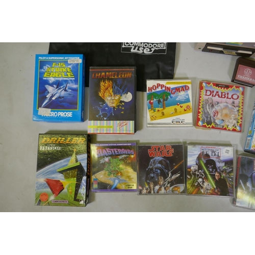 26 - Two Commodore 64, accessories, floppy disk readers, programs and games to include Ghostbusters, Supe... 