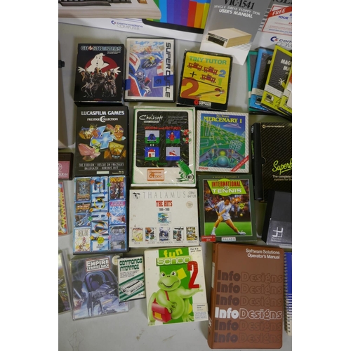 26 - Two Commodore 64, accessories, floppy disk readers, programs and games to include Ghostbusters, Supe... 