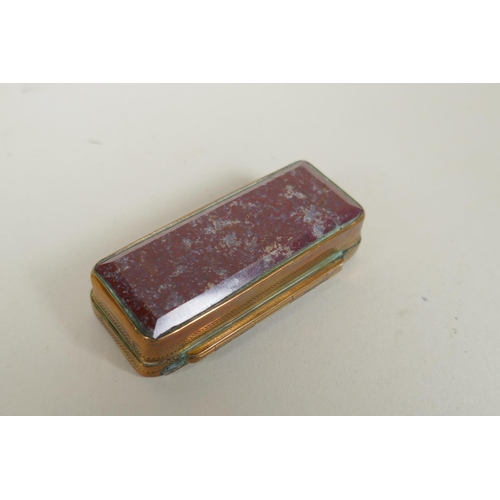 27 - An antique brass snuff box with specimen stone set lid and jasper set base, together with a brass an... 