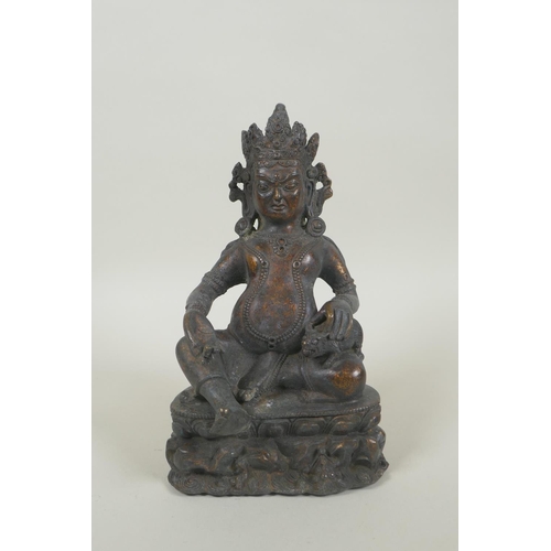 270 - A Tibetan bronze figure of Jambhala with remnants of gilt patina, 19cm high