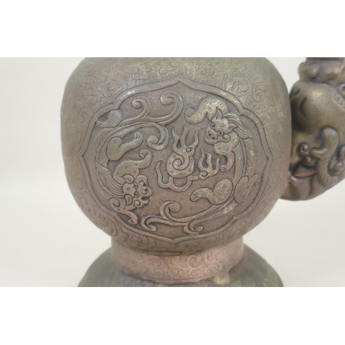 271 - A Tibetan white metal bumpa vase with repousse dragon/kylin decoration, 26cm high