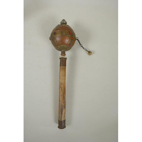 275 - A Tibetan bamboo and copper prayer wheel with brass mounts, and a bronze singing bowl with script de... 